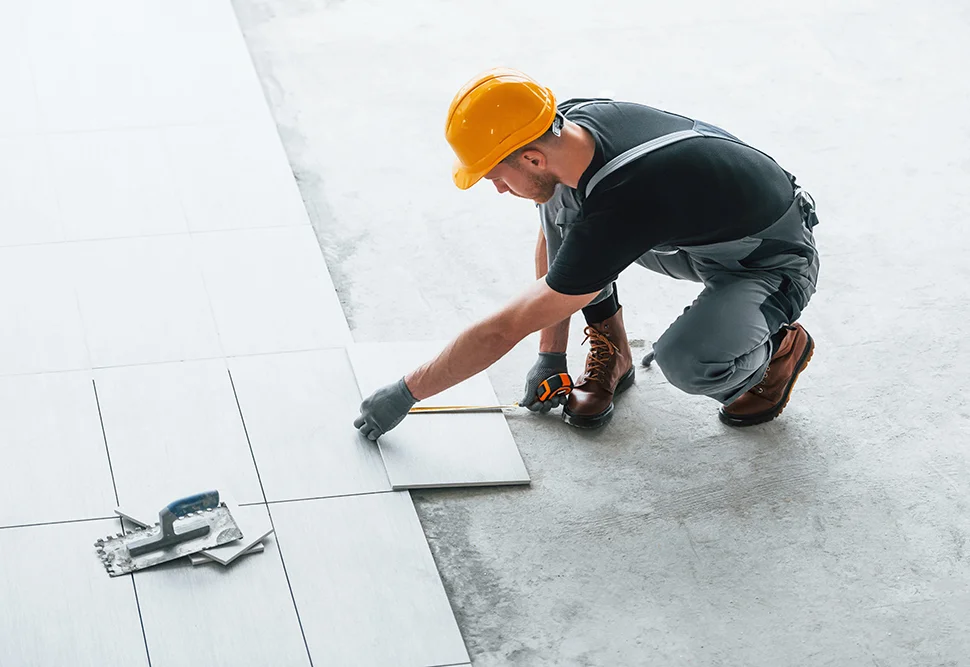 a man measuring tiles