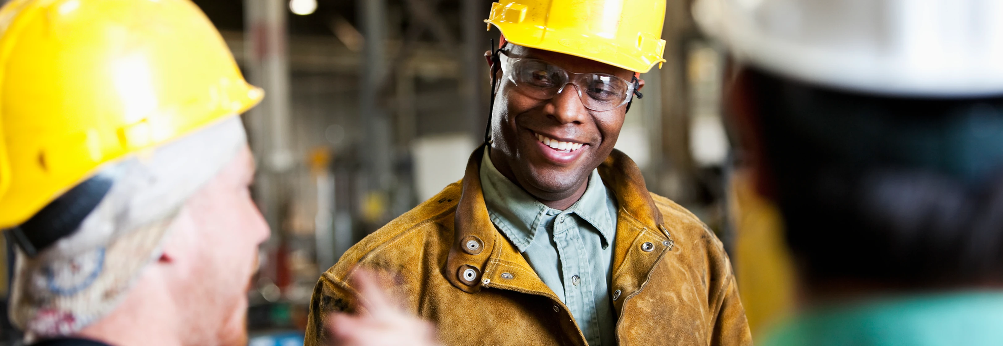 men talking wearing hard hats